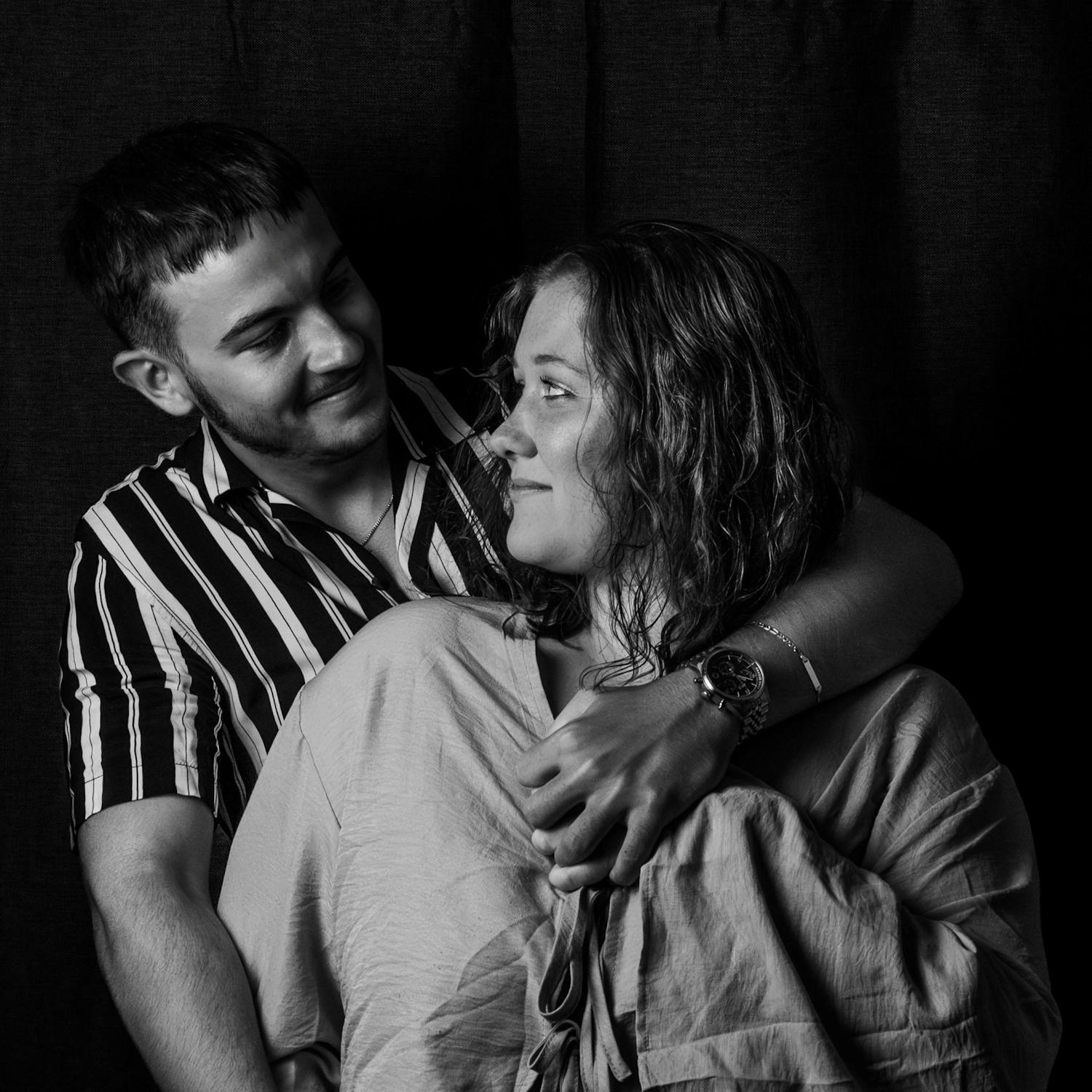 Intimate black and white portrait of a couple gazing at each other — aftercare and emotional connection