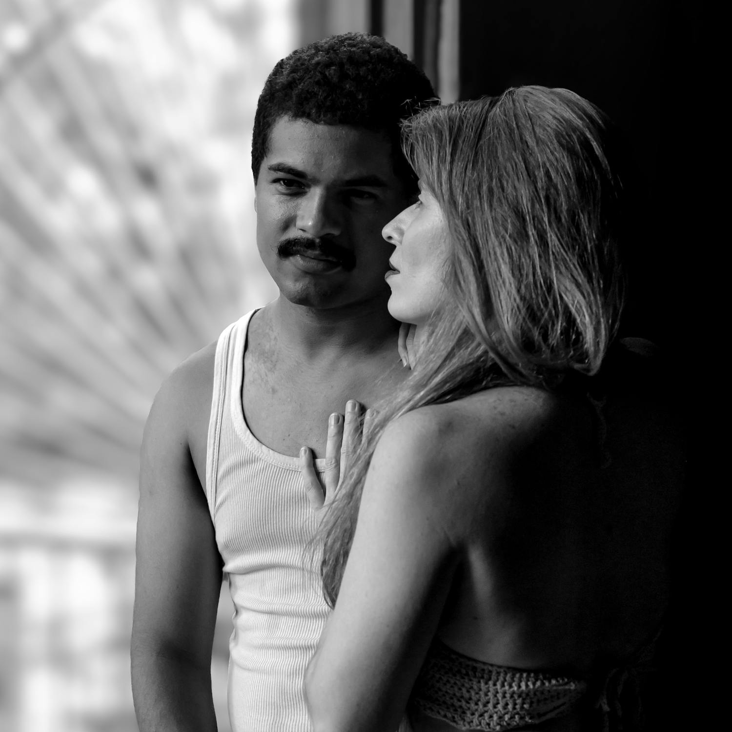 Black and white close-up of two people in an intimate moment — trust and communication in BDSM